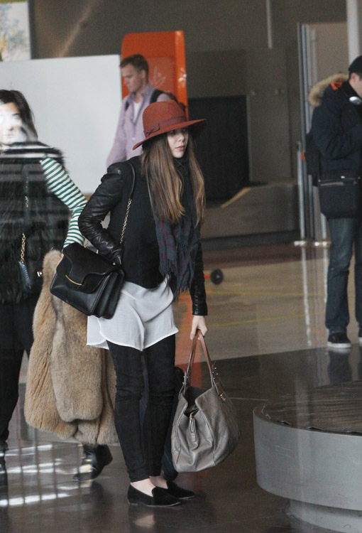 Elizabeth Olsen carries a black Alexander McQueen Heroine Shoulder Bag and a large Chanel tote at the airport in Paris. (2)