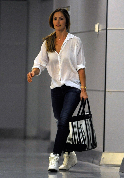 Minka Kelly carries a Coach x Krink Weekend Tote at LAX (2)