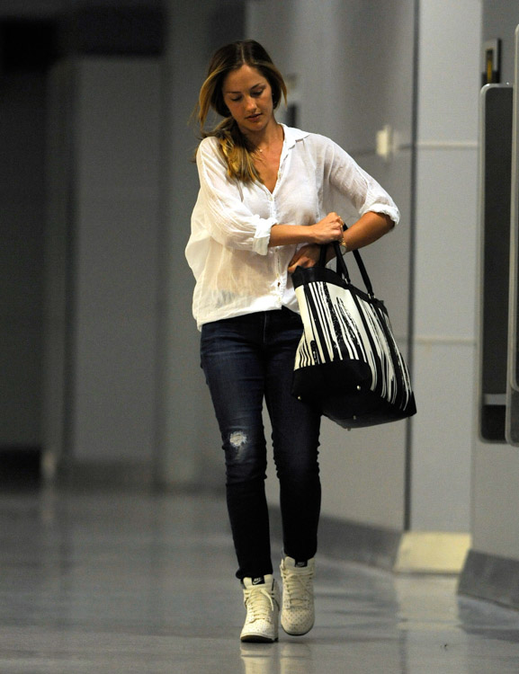 Minka Kelly carries a Coach x Krink Weekend Tote at LAX (4)