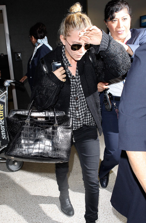 Mary-Kate Olsen carries The Row's Alligator Backpack and The Row's Carry All Tote in Alligator (1)