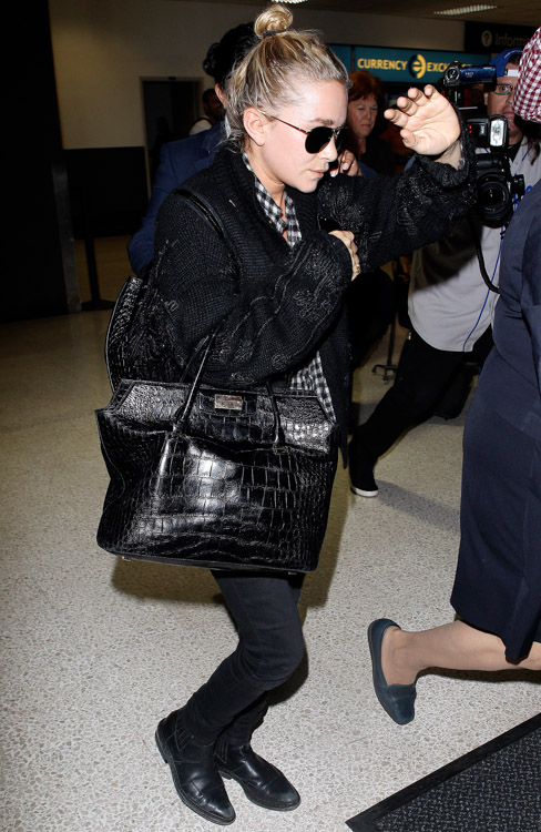 Mary-Kate Olsen carries The Row's Alligator Backpack and The Row's Carry All Tote in Alligator (4)