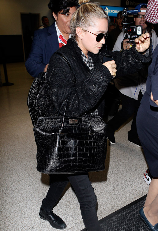 Mary-Kate Olsen carries The Row's Alligator Backpack and The Row's Carry All Tote in Alligator (3)