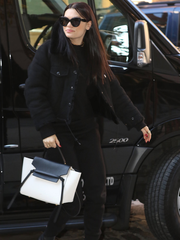 Jessie J is cheerful in all black as she returns to her SoHo hotel this afternoon