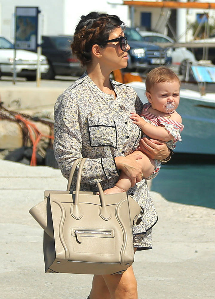 Khloe Kardashian and Kourtney Kardashian carry her children to a yacht ride in Mykonos, Greece