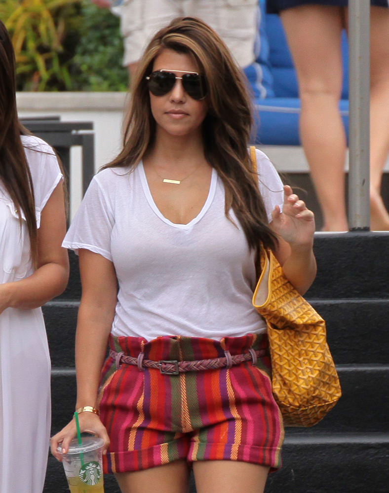 Kim kardashian and sister Kourtney hitting the beach in Miami Beach.