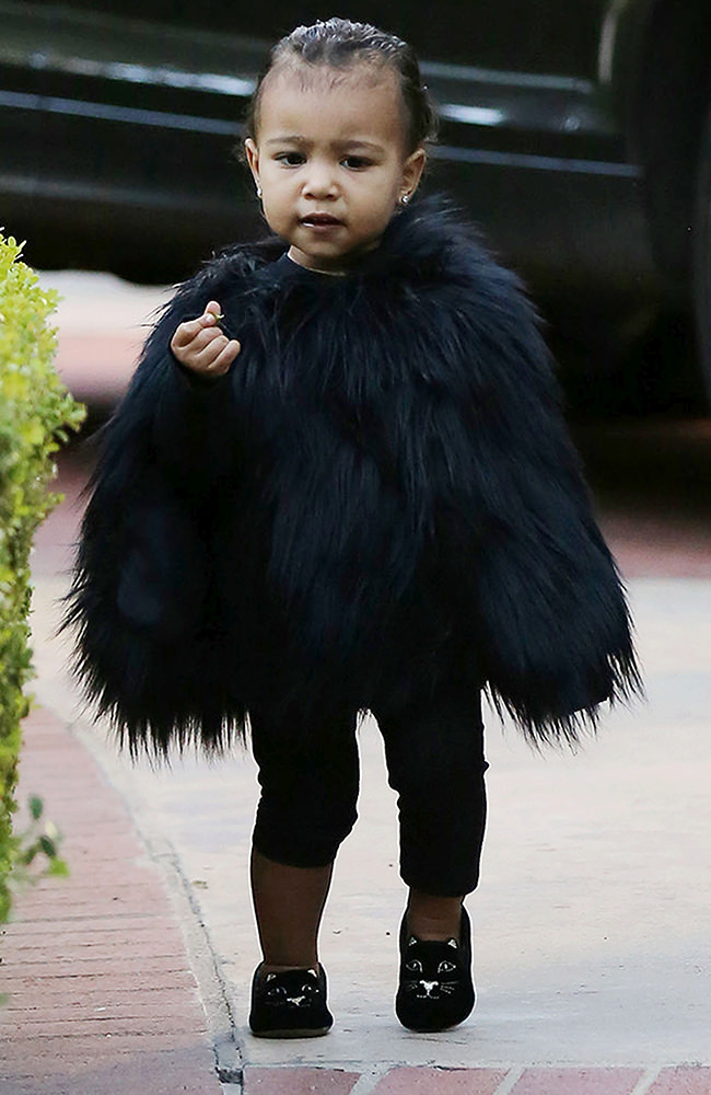 Kim Kardashian and her baby North, dressed in a black fur cape, arriving at a friend's house in Beverly Hills ****NO DAILY MAIL SALES****