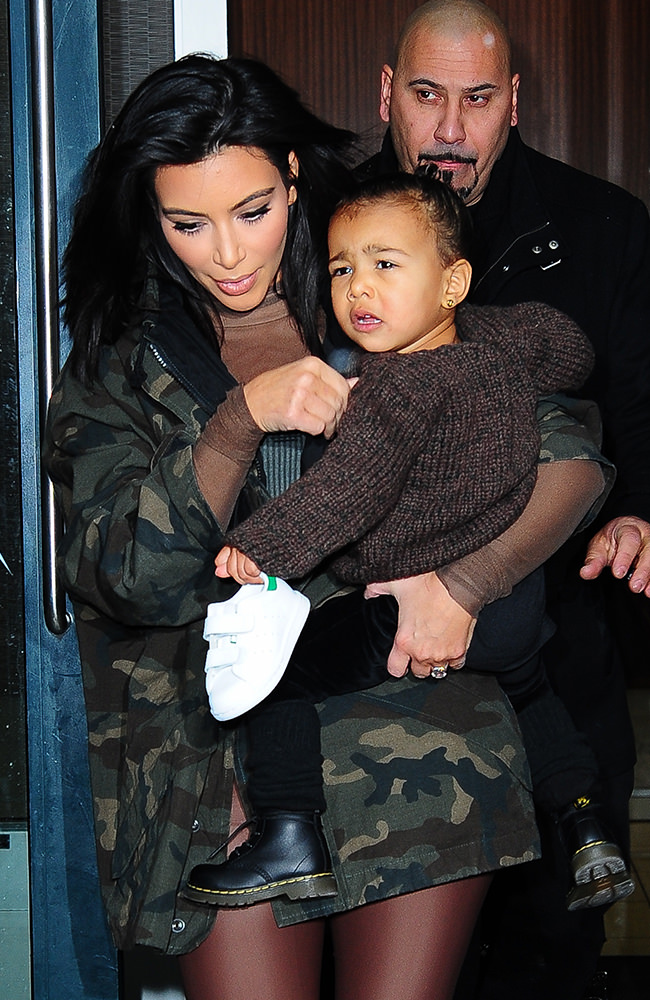 Kim Kardashian carries her daughter North West onto a show at New York Fashion Week