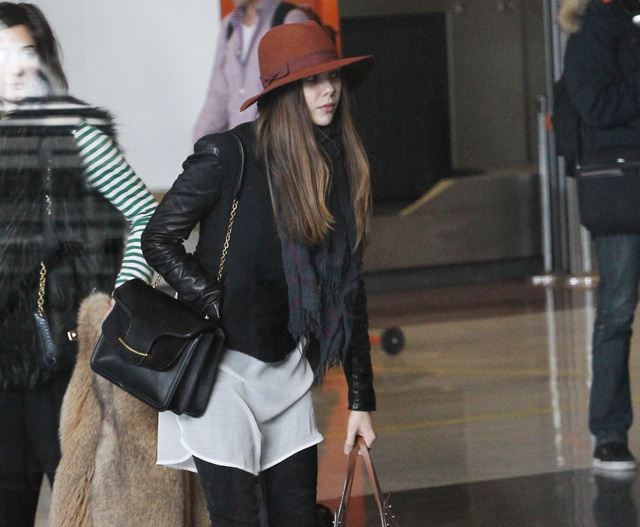 Elizabeth Olsen carries a black Alexander McQueen Heroine Shoulder Bag and a large Chanel tote at the airport in Paris. (5)