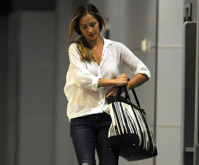 Minka Kelly carries a Coach x Krink Weekend Tote at LAX (5)