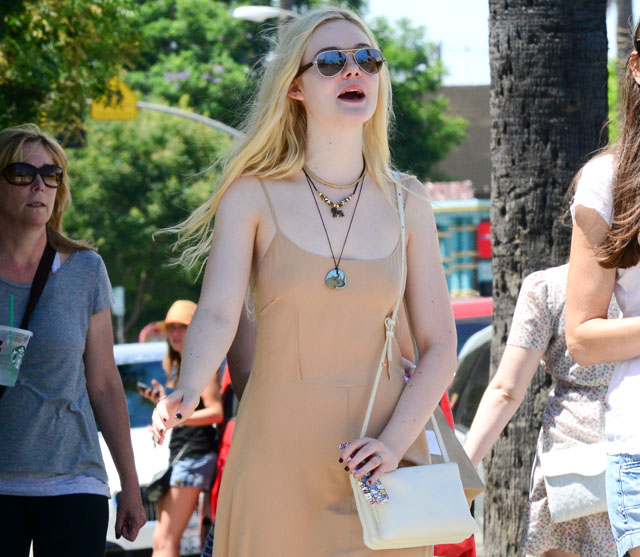 Elle Fanning carries an ivory Celine Trio Bag (5)