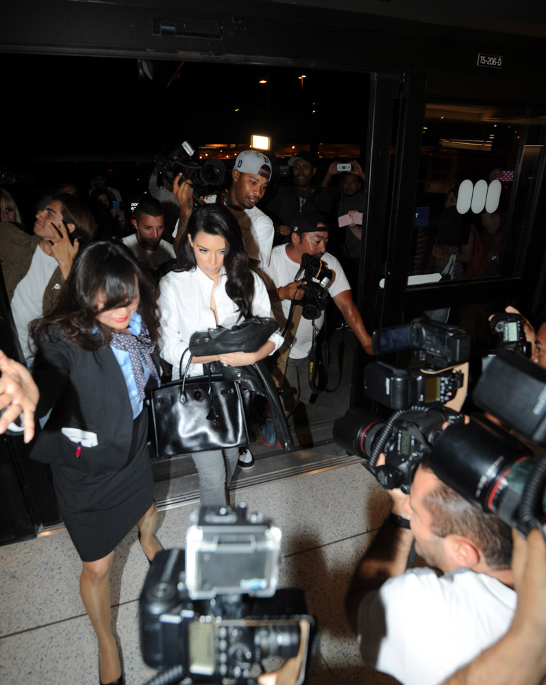 Kim Kardashian Clutches Her Trusty So Black Birkin in a Paparazzi Scrum -  PurseBlog