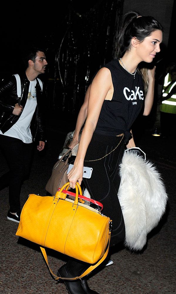 Kendall Jenner with Louis Vuitton coin purse, January 7, 2012