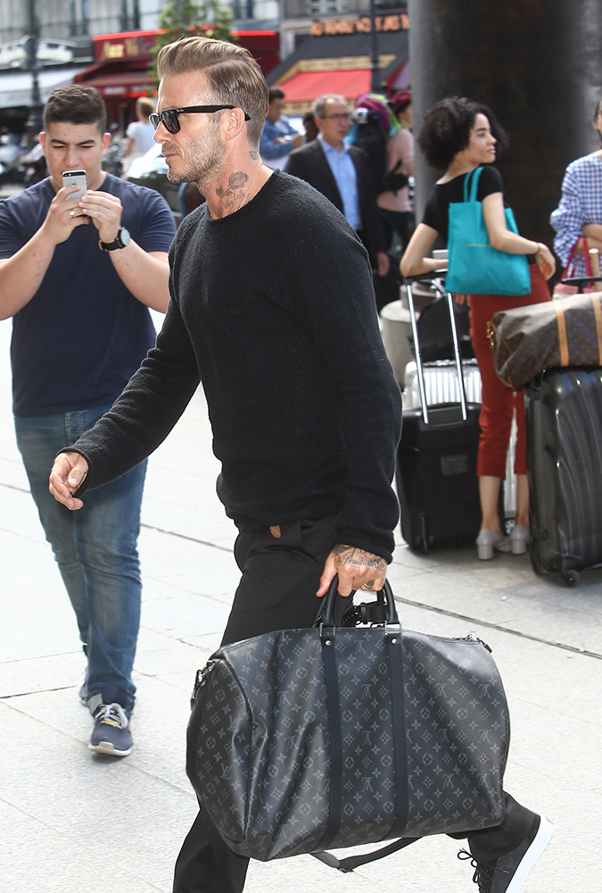 David Beckham, carrying his Louis Vuitton travel bag, gets a