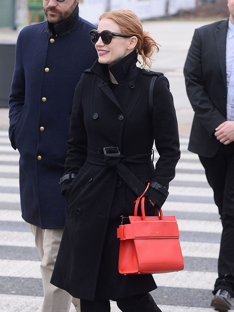 Jessica Chastain matches her lips to her hot pink designer bag in