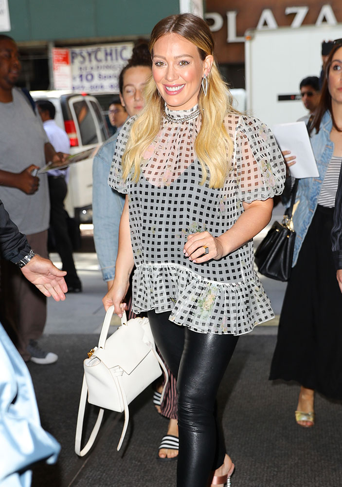 Hilary Duff arrives at the airport carrying Louis Vuitton luggage