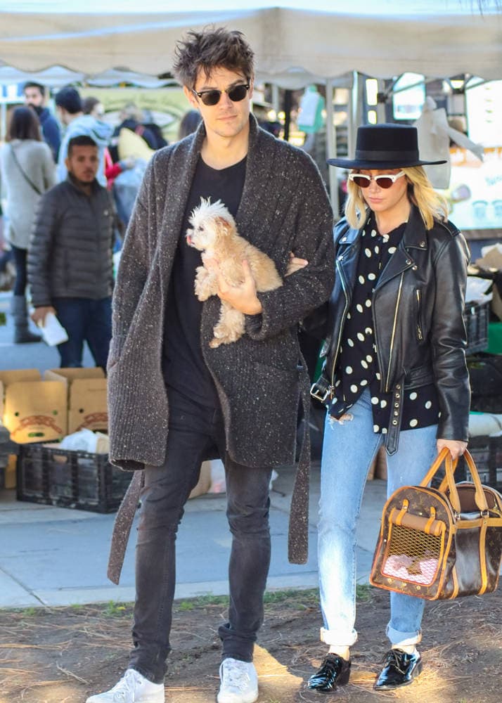 Ashley Tisdale carrying a Louis Vuitton shopping bag while out