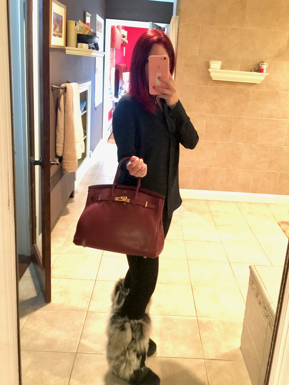 Me circa 2017 with my 35cm Birkin in Rouge H. As you can see, it's a great size for carrying lots of things. I am amused because as I type this, I am wearing the very same leggings and boots. Some things never change! However, I have painted all my walls gray since I took this photo.