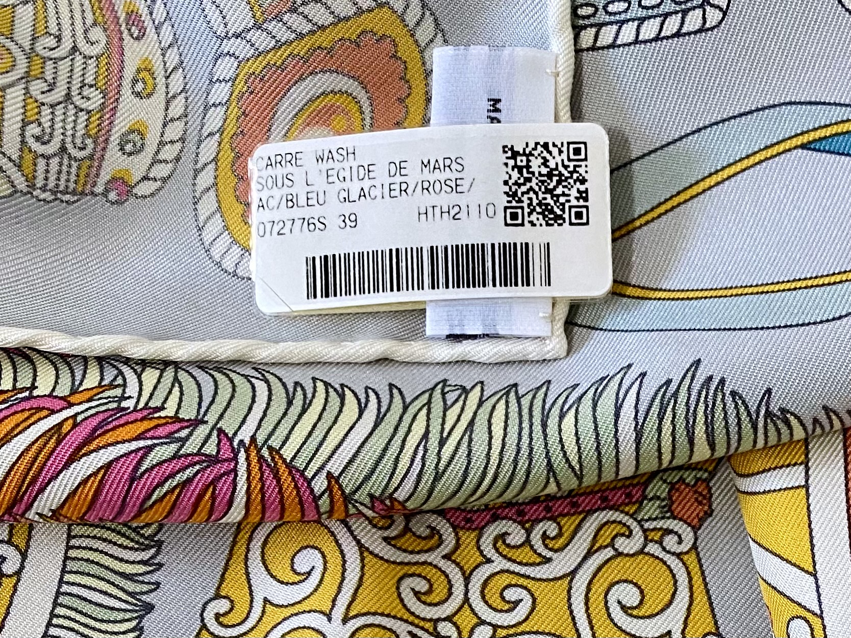 A plastic "store tag" (over the care tag) showing the colorway number and colors. Photo via @The_Notorious_Pink