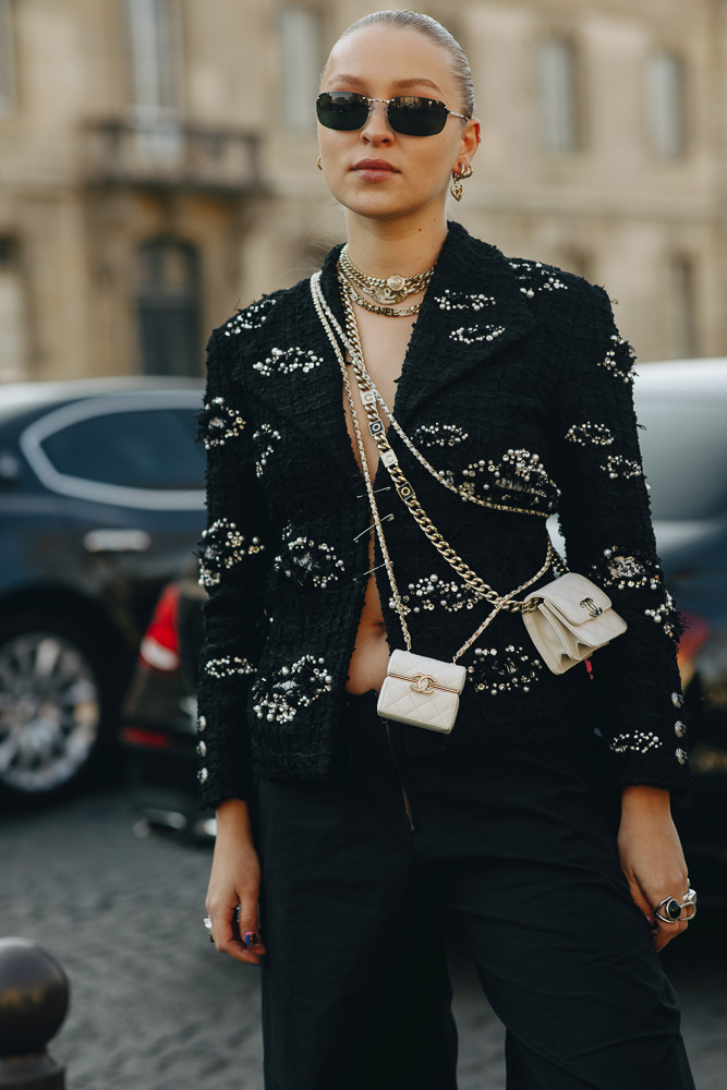 Candela Pelizza, wearing a black top, blue jeans with Chanel belt