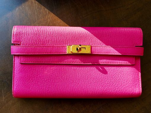 The Exterior of this Rose Shocking Kelly Wallet has the Kelly Closure. Photo via @The_Notorious_Pink.