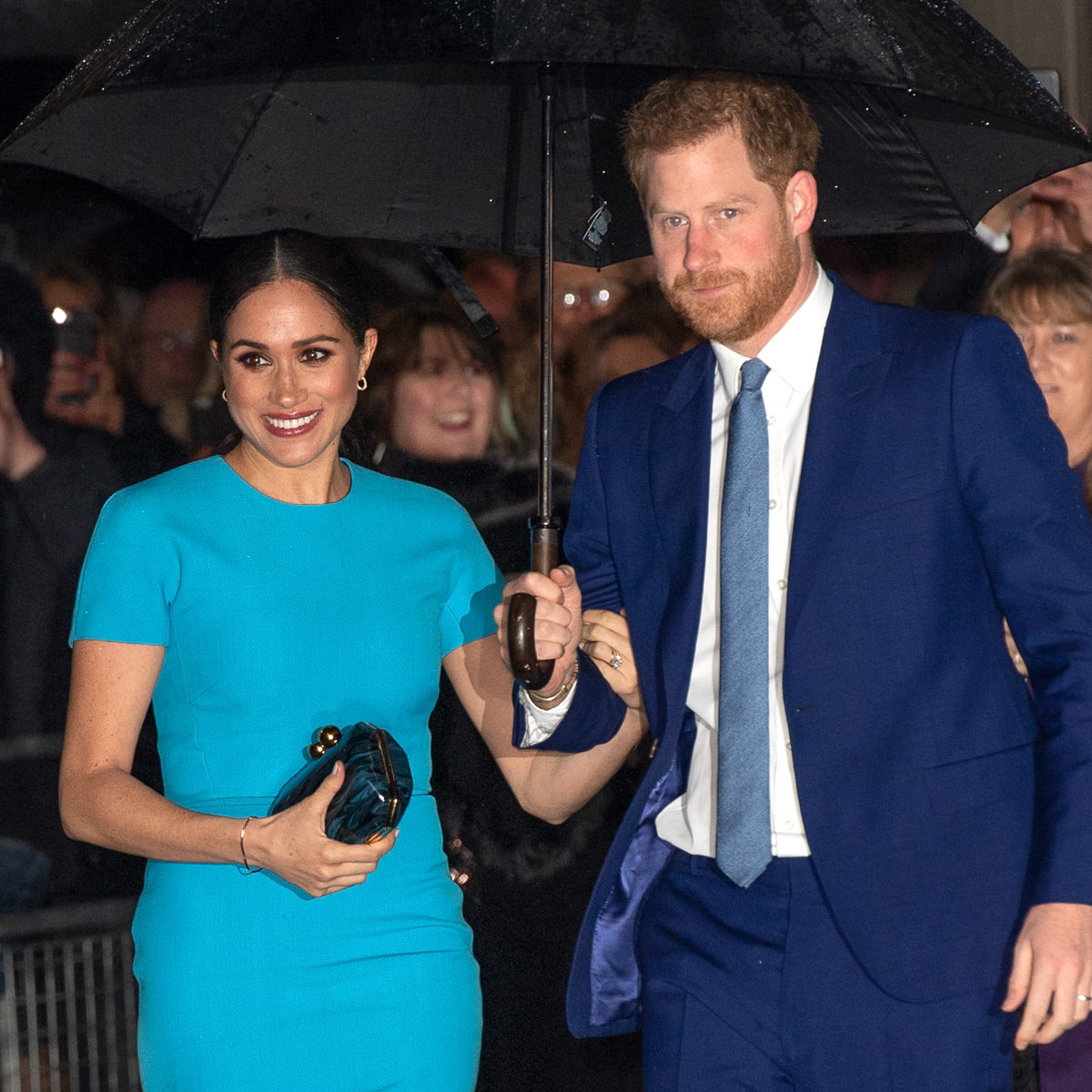 Meghan Markle with her Stella McCartney Lucia Blue Marbled Plexi Clutch