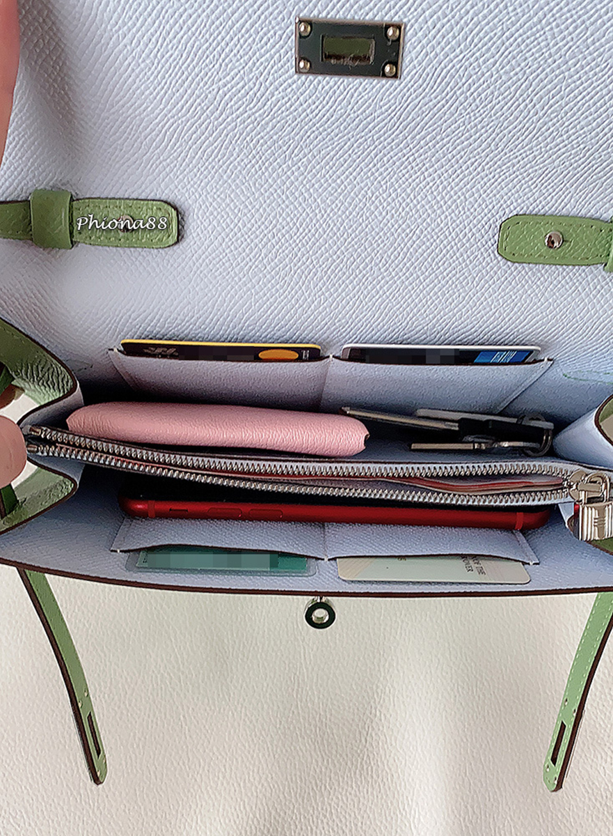 What fits in a Kelly To Go. Here: iPhone 8, 4 cards, Keys, Bastia coin case, and money in the center zipper. The TPFer adds that she could have also fit a lipstick, tissues, an Airpods Pro case and more cards into the slots, and that it is large enough to fit an iPhone Pro. Photo via TPFer @Phiona88.