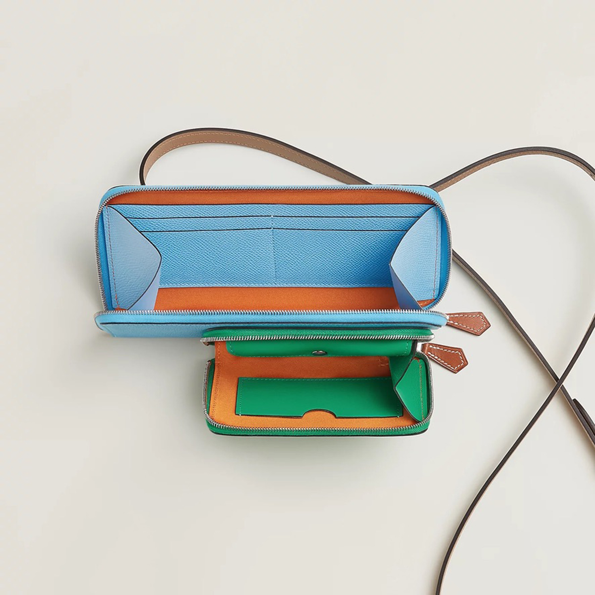 The interior of the Hermès Nouveau To Go Wallet in Celeste/Menthe/Chai/Mandarine. Photo via Hermes.com