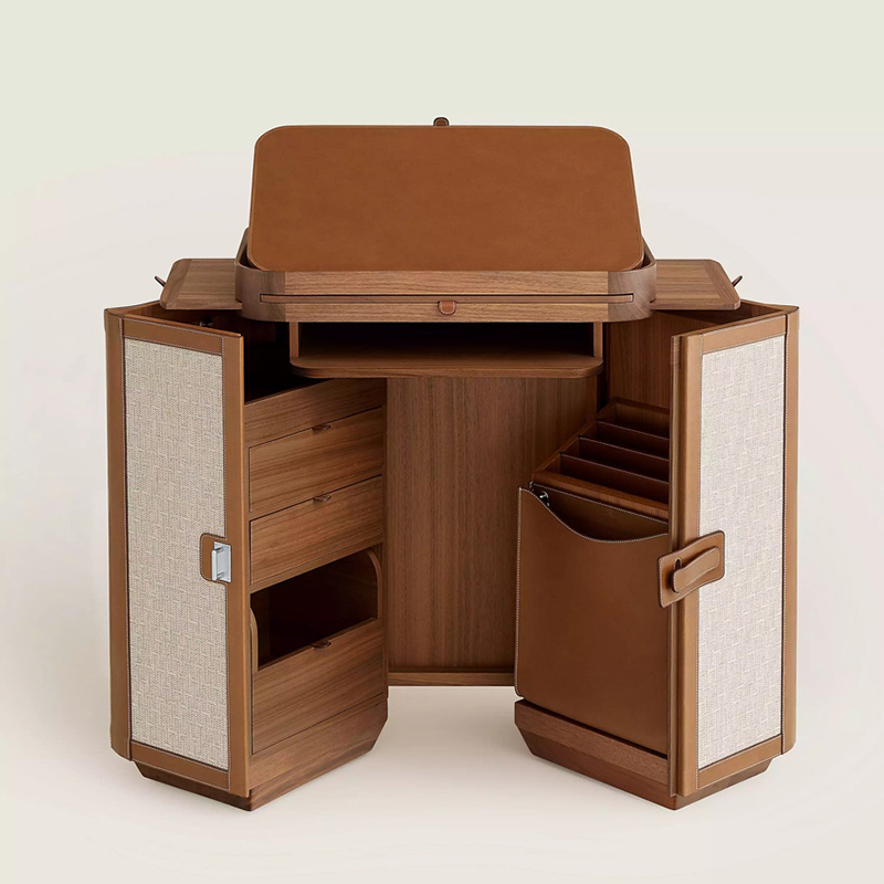 Les Necessaires d'Hermes Folding desk with Canaletto walnut frame. Exterior clad in taurillon H leather and "Cravache" fabric. Interior in Canaletto walnut and taurillon H leather. Leather closure with brushed stainless steel hasp. Featuring a fold-out desktop and retractable pulls, drawers, a magazine rack, a removable pouch and a secret compartment. Measures 18.9" long x 24.4" high x 12.9" deep, $68,000. Photo via Hermès.com.