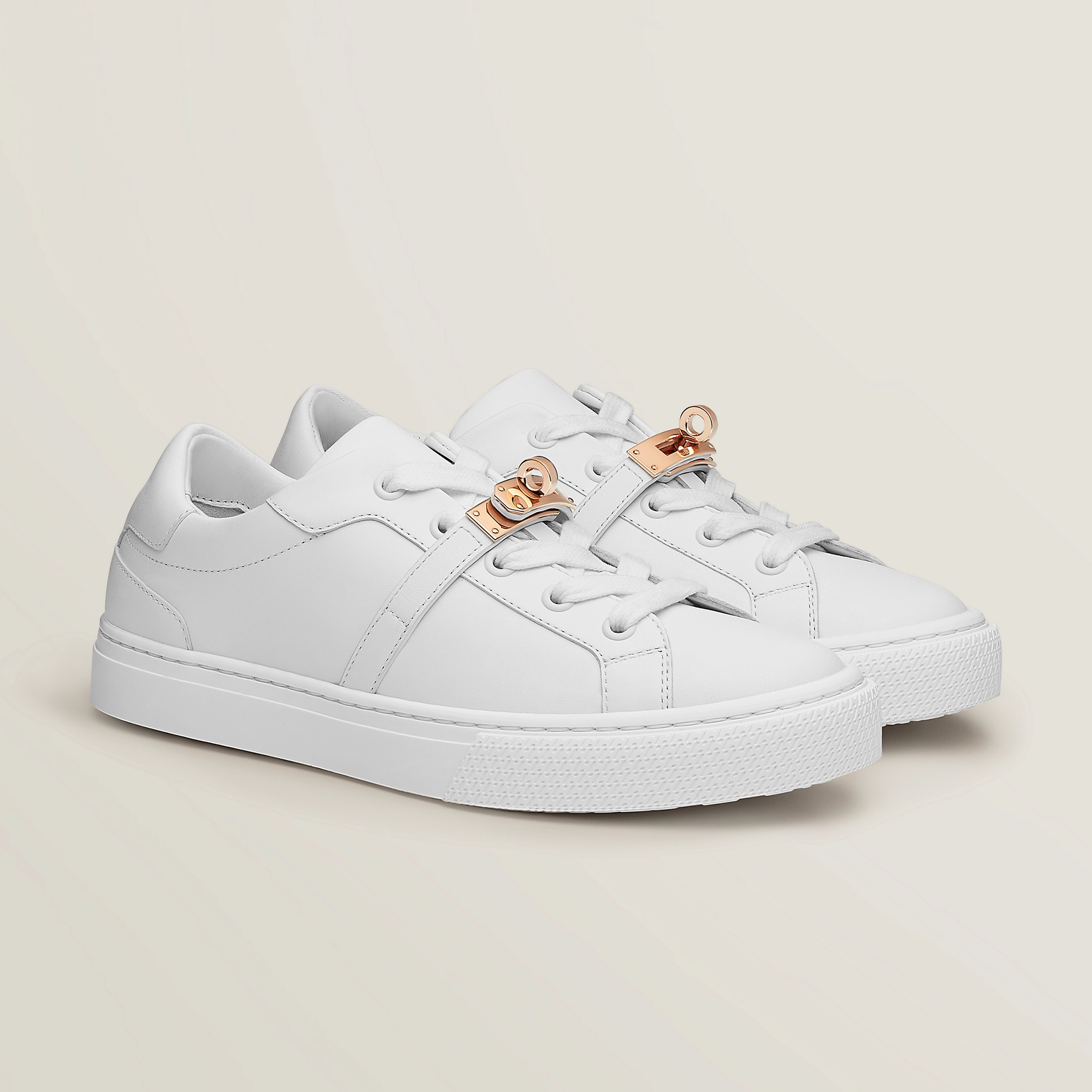 Blanc Day Sneaker in calfskin with functional rose gold-plated Kelly buckle, $1250. Photo via Hermès.com.
