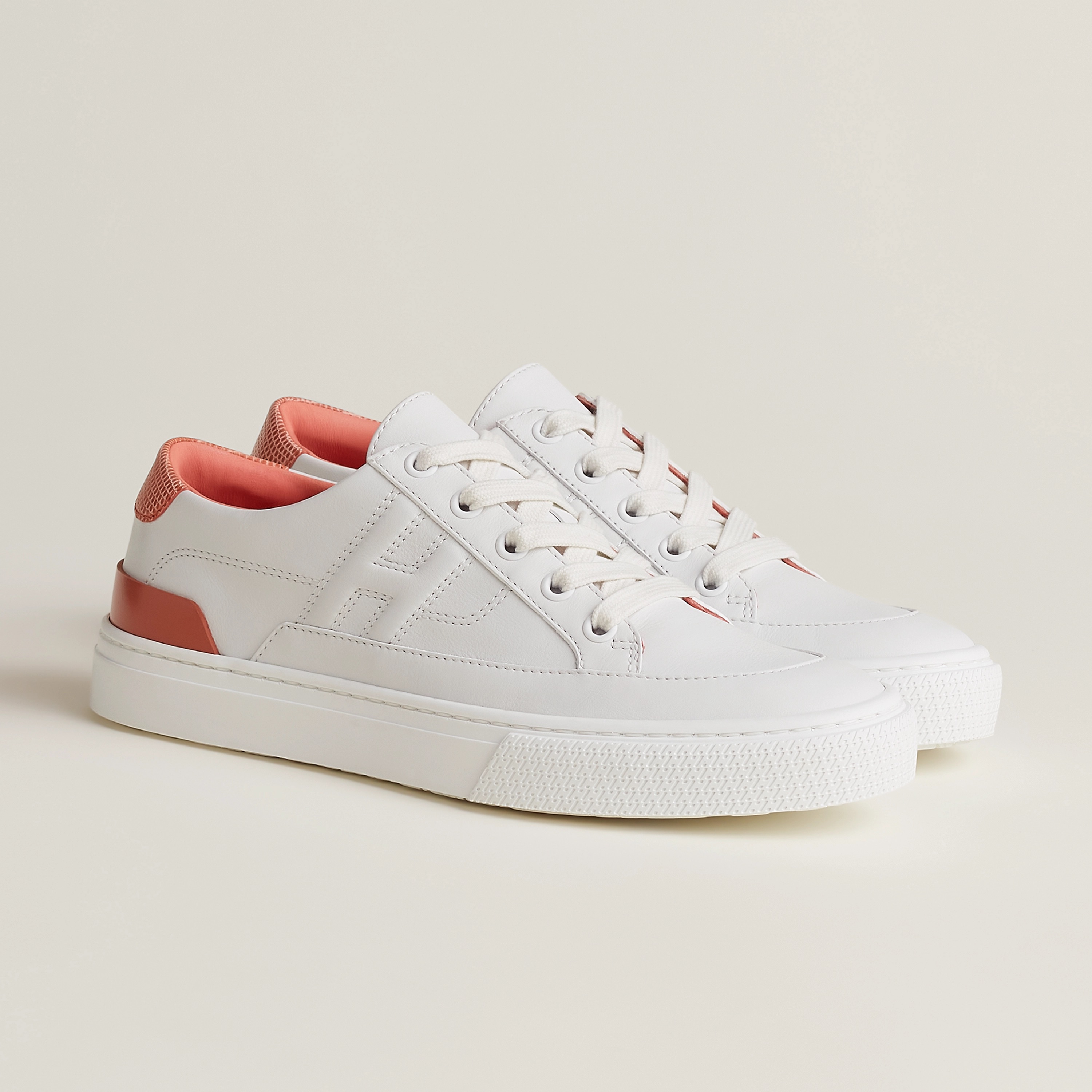 Blanc / Orange Joey Deep Sneaker in calfskin and shiny lizard leather, $970. Photo via Hermès.com.