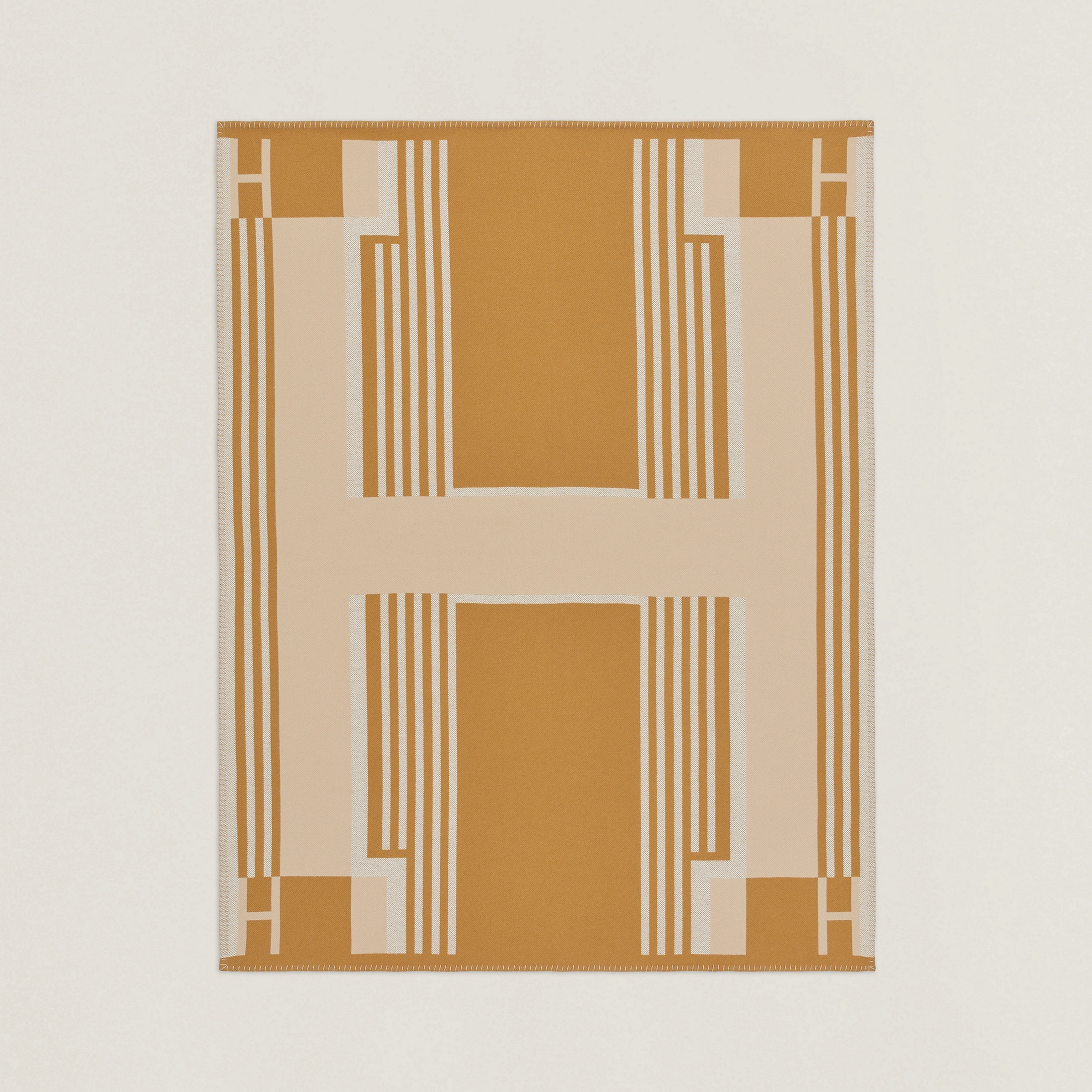 Ithaque blanket in camel/beige. Blanket in jacquard woven wool and cashmere. Measures 53.1" x 68.9", $1775. Photo via Hermès.com.
