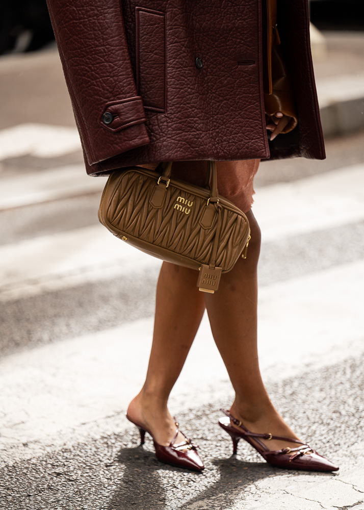 Milan, Italy - February, 25, 2022: woman wears pink Miu Miu Wander  Matelasse hobo bag in regenerated nylon, street style details Stock Photo