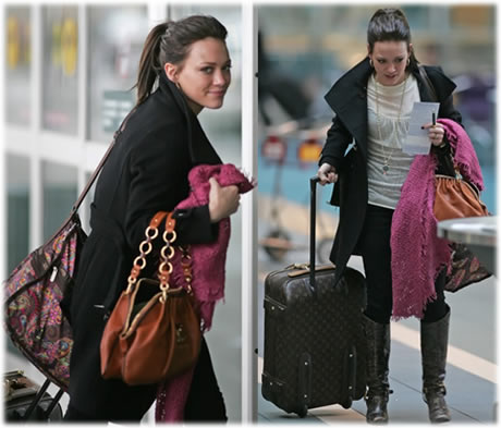 Hilary Duff arrives at the airport carrying Louis Vuitton luggage